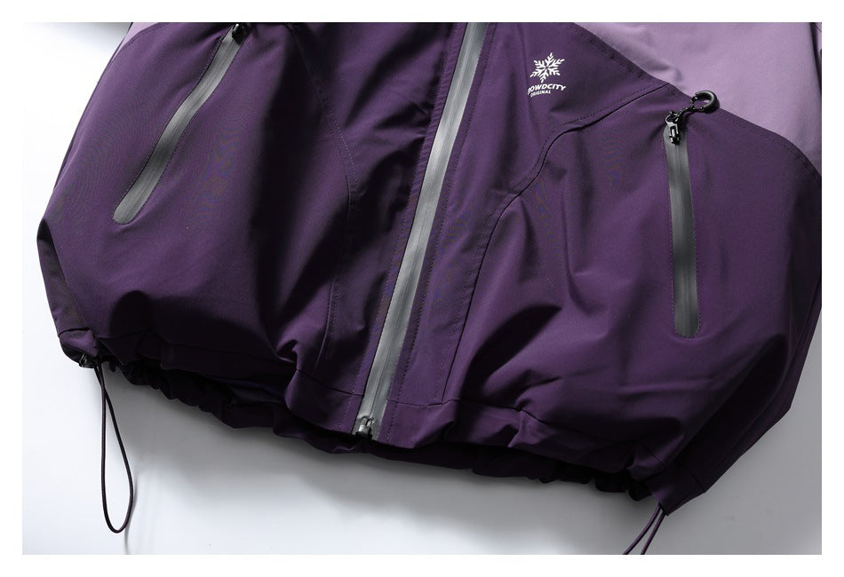 Partial flat-lay front view of a purple jacket with contrast panels, zip pockets, and drawcord hem.