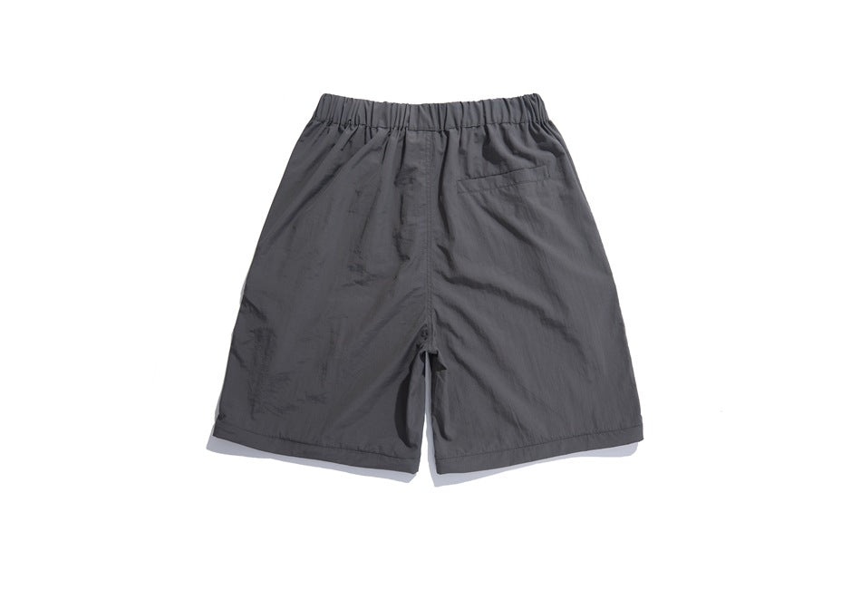 Back of charcoal gray shorts with an elastic waistband and a single rear pocket.