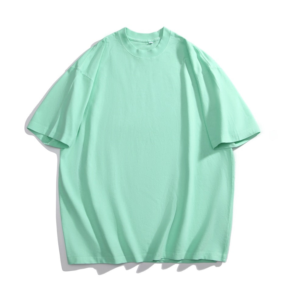 Mint green short-sleeve crew neck T-shirt with dropped shoulders, flat lay on a white background