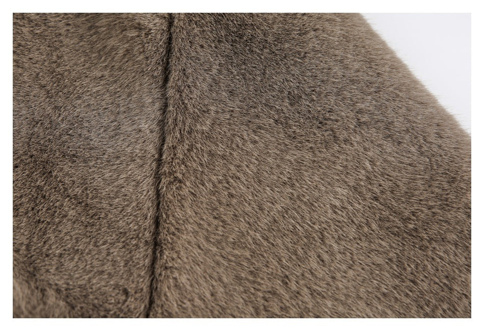 Close-up of taupe-brown plush fur with a narrow vertical seam or edge.