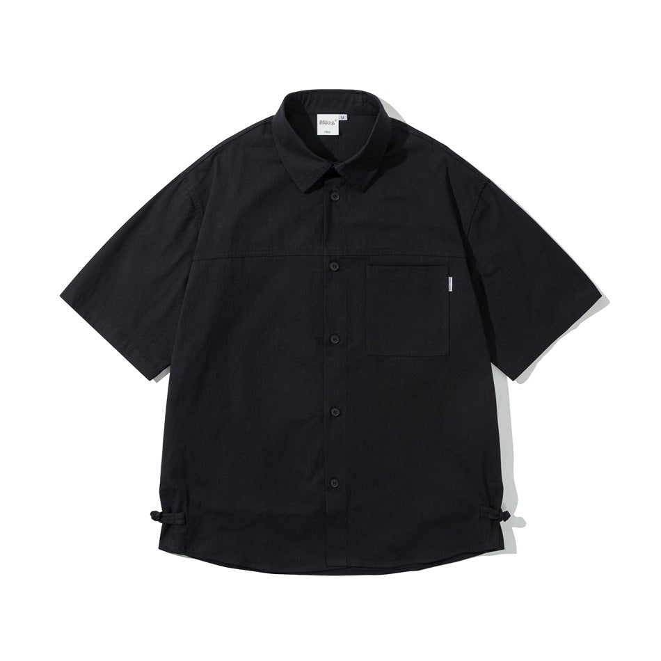 Black short-sleeve button-up shirt, front flat lay, chest pocket and knot-button loops at side hems