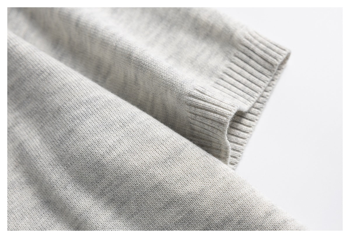 Close-up of the light gray knit polo sleeve with a ribbed cuff.