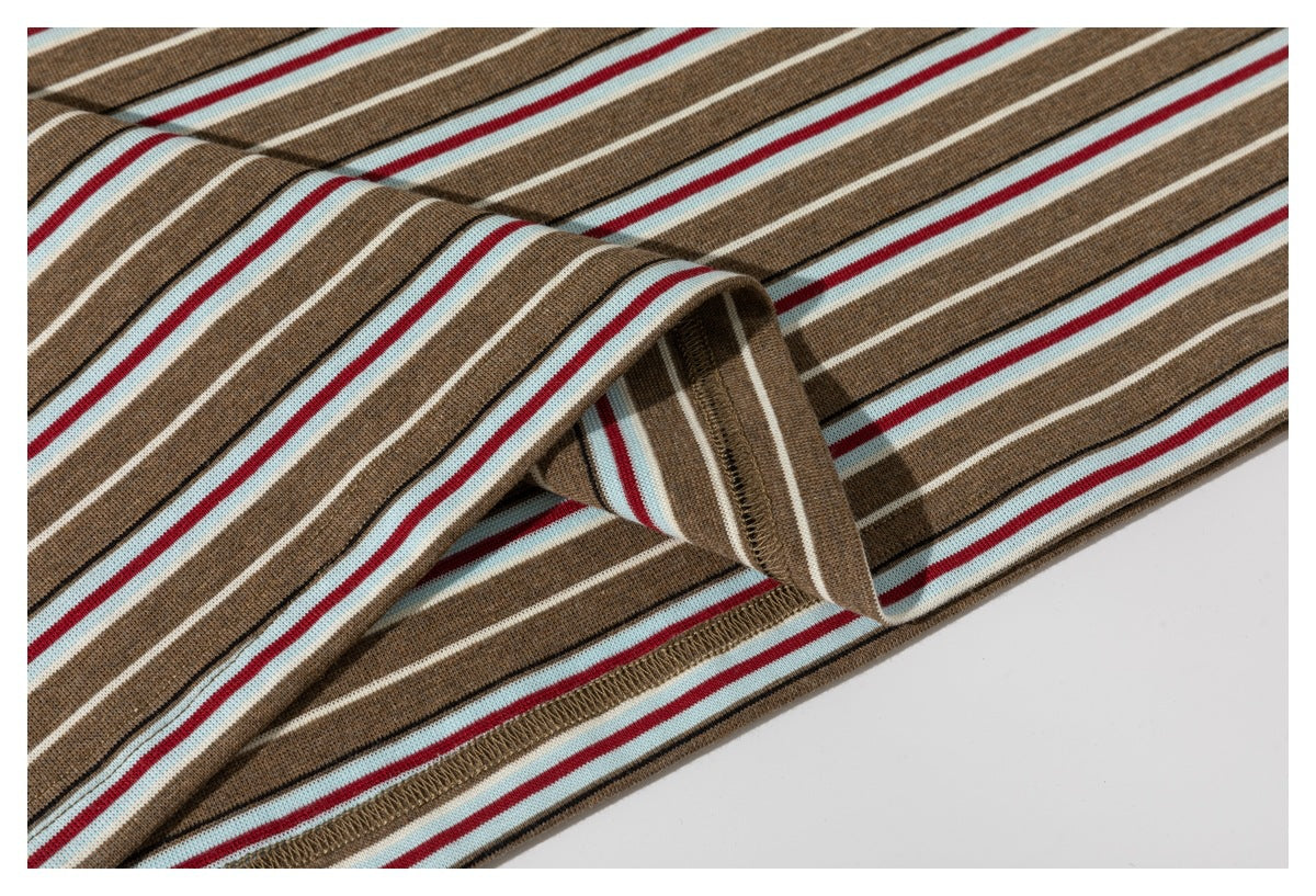 Close-up of the striped T-shirt's folded hem and stitched edge.