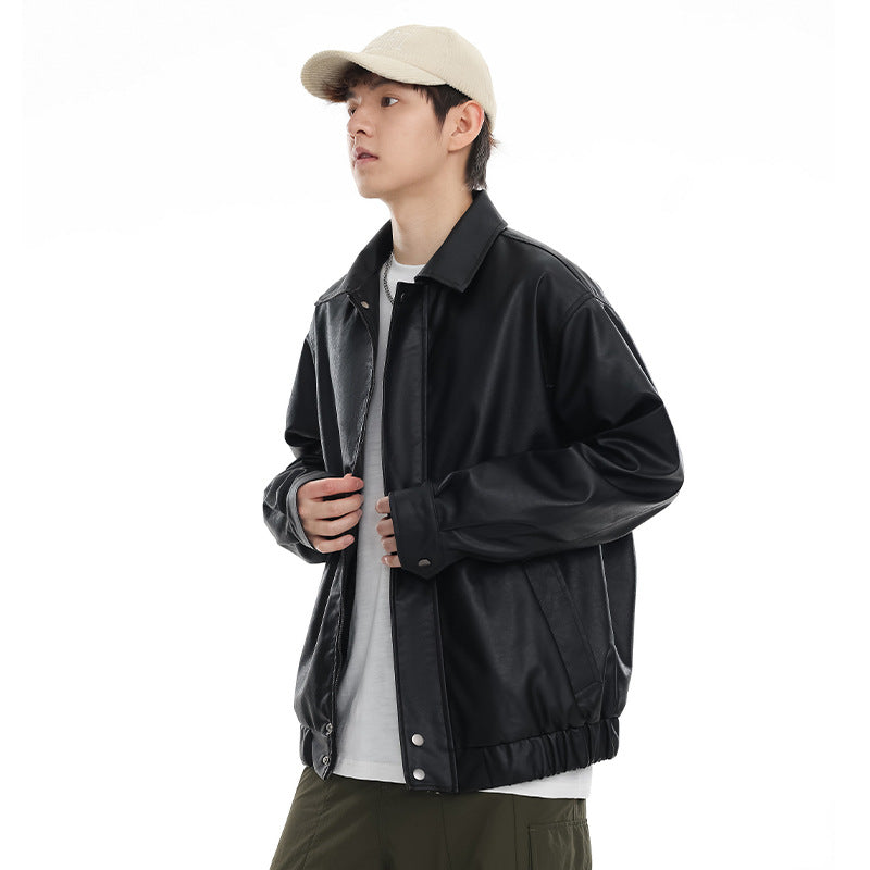 Model wearing a black collared jacket with a snap-front placket, angled pockets and elastic hem.