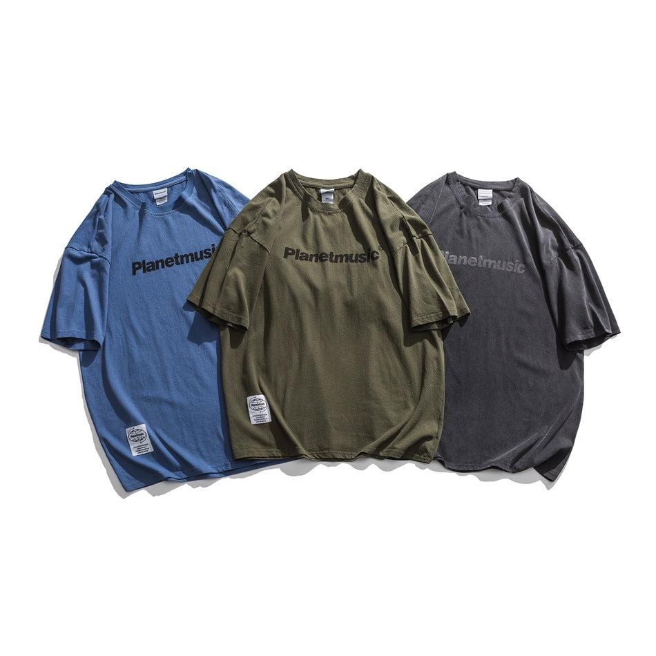 Three oversized short-sleeve T-shirts in blue, olive green, and charcoal, shown from the front.