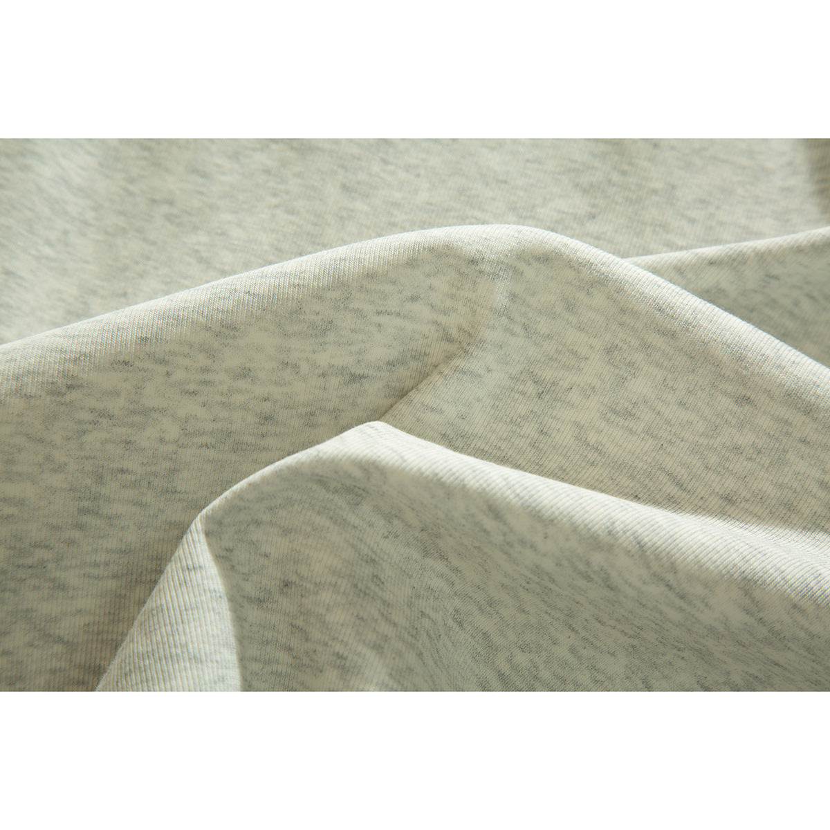 Close-up showing the lightly textured, heathered light gray fabric of a polo shirt.