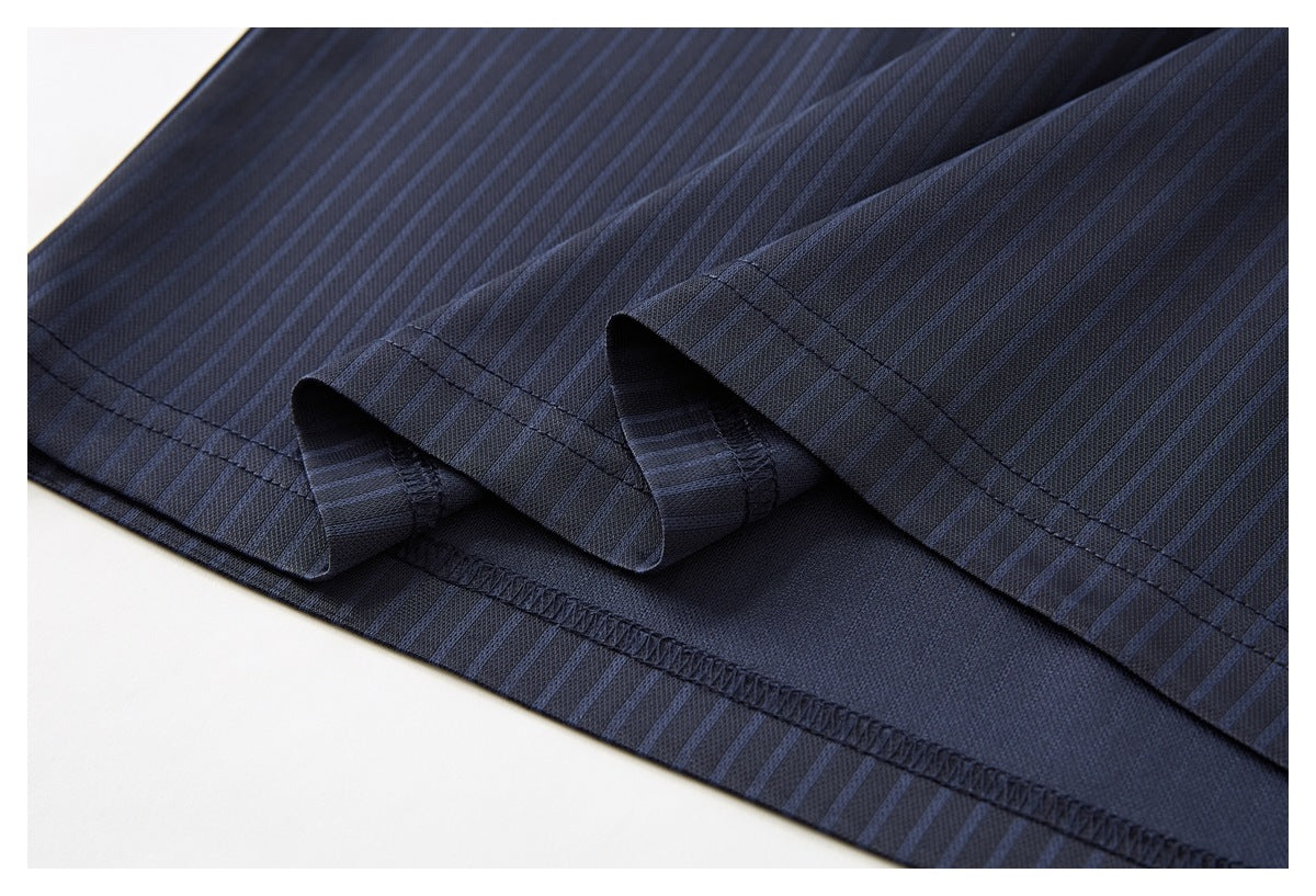 Close-up of a dark navy pinstriped shirt hem with a side slit and visible inner overlock stitching.