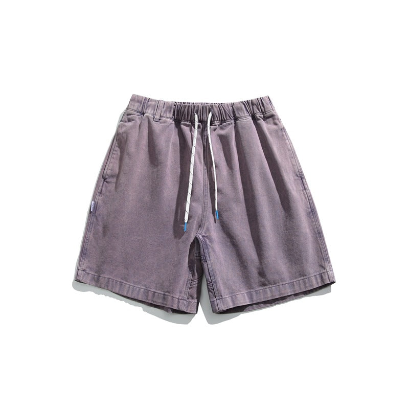 Dusty purple washed shorts with white drawstring and elastic waist, flat lay front view