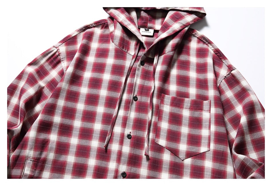 Close-up of the red plaid shirt's hood, button front, drawstrings, and chest pocket.