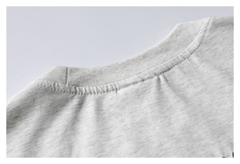 Close-up of the back neckline seam on a light gray marl shirt.
