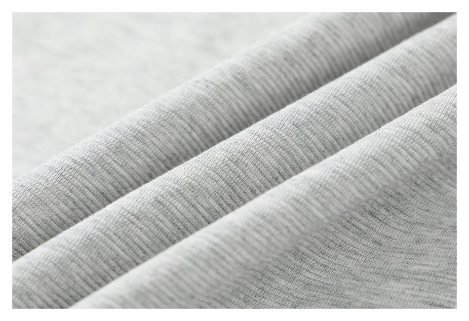 Macro view of the light gray jogger fabric, showing its fine textured knit surface.