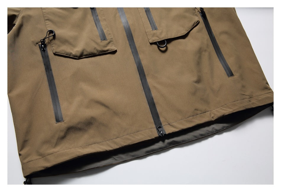 Cropped flat-lay front view of a tan jacket with flap pockets, vertical zippers and a dark center zipper.