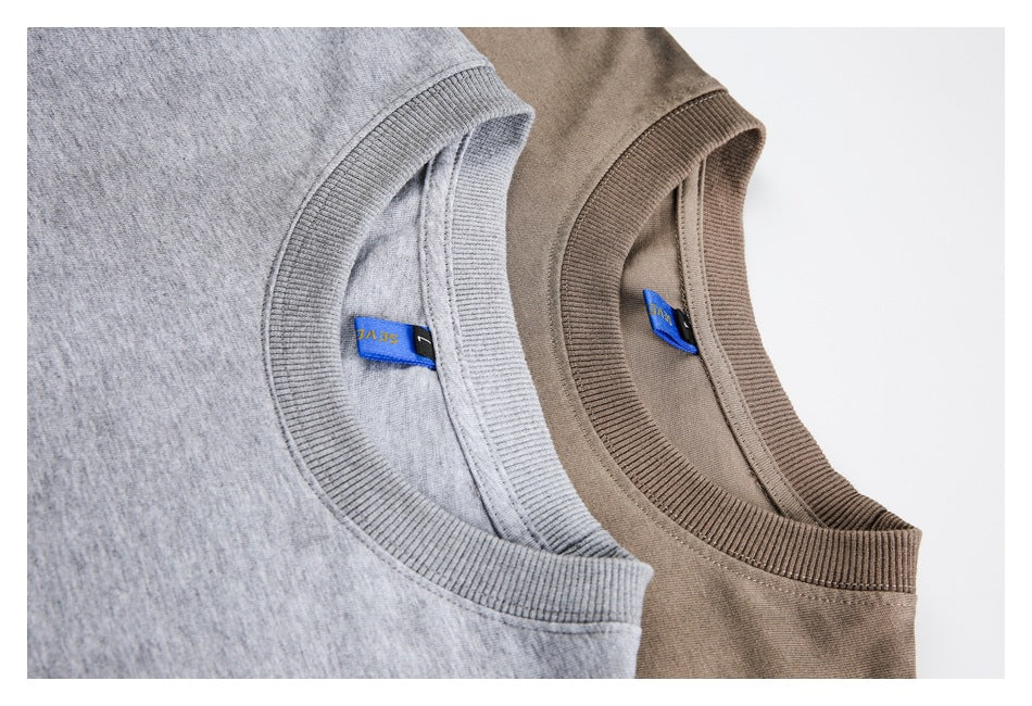 Close-up of ribbed crew necks on heather gray and taupe tops, showing two colorways.
