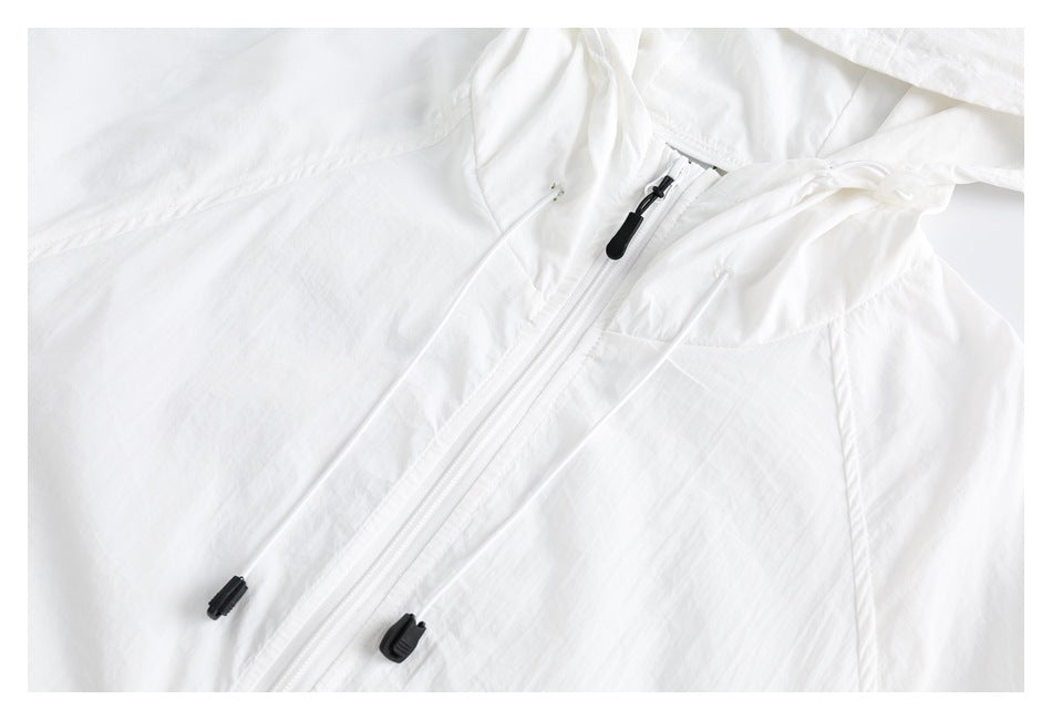 Close-up of a white hooded jacket's front zipper, drawcords, and seam details.