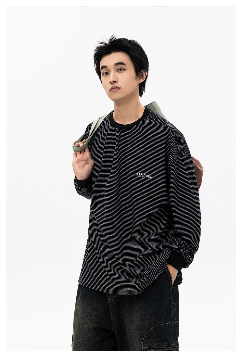 Man modeling a black long-sleeve shirt with fine gray stripes, black trim, and small chest lettering.