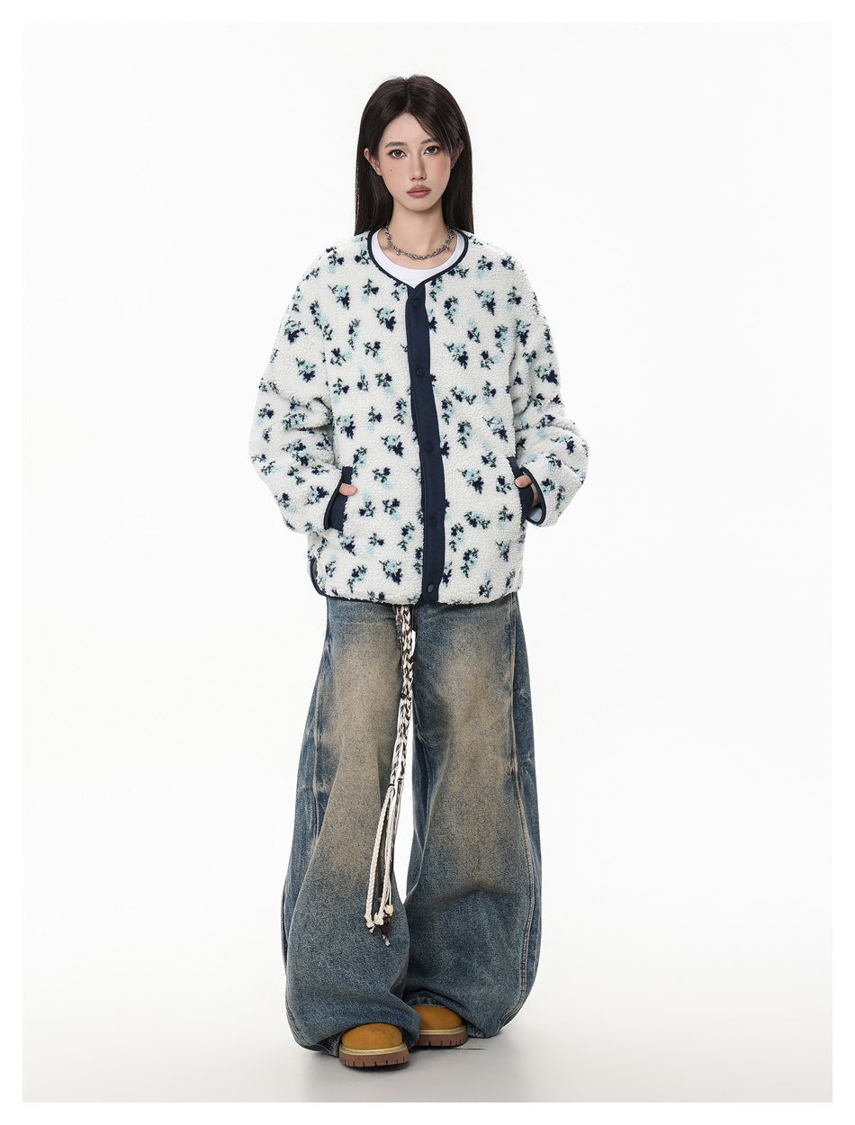 Model wearing white floral fleece-textured snap-front jacket with wide-leg faded jeans and tan boots, full-length view