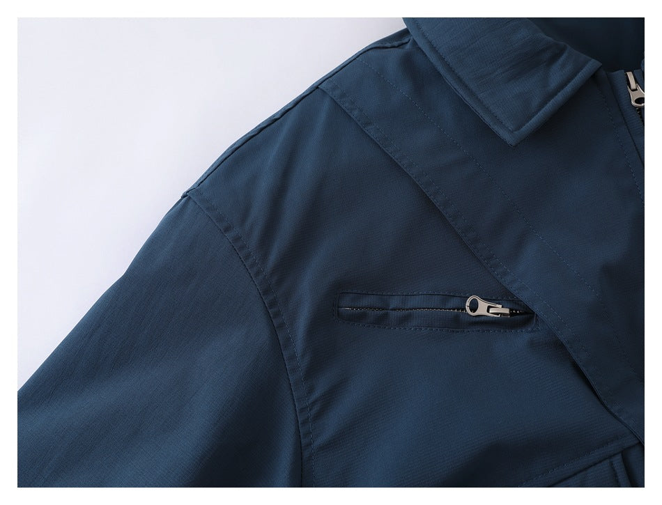 Close-up of a dark navy jacket sleeve and chest area, showing a horizontal zip pocket and stitched seams.