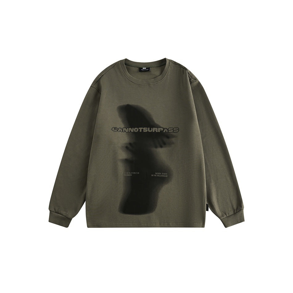 Olive green long-sleeve crew-neck top with blurred shadow figure graphic and CANNOTSURPASS lettering, front flat view