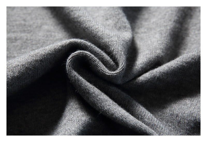 Close-up of gray knit fabric arranged in soft folds.