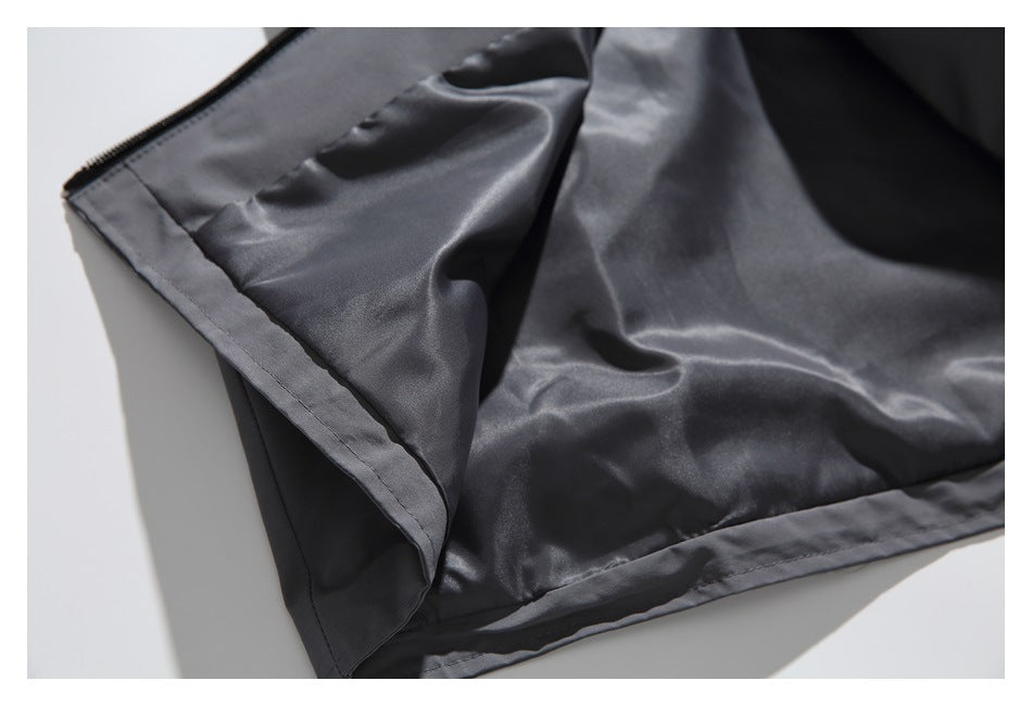 Close-up of the charcoal jacket's inner lining and stitched hem.
