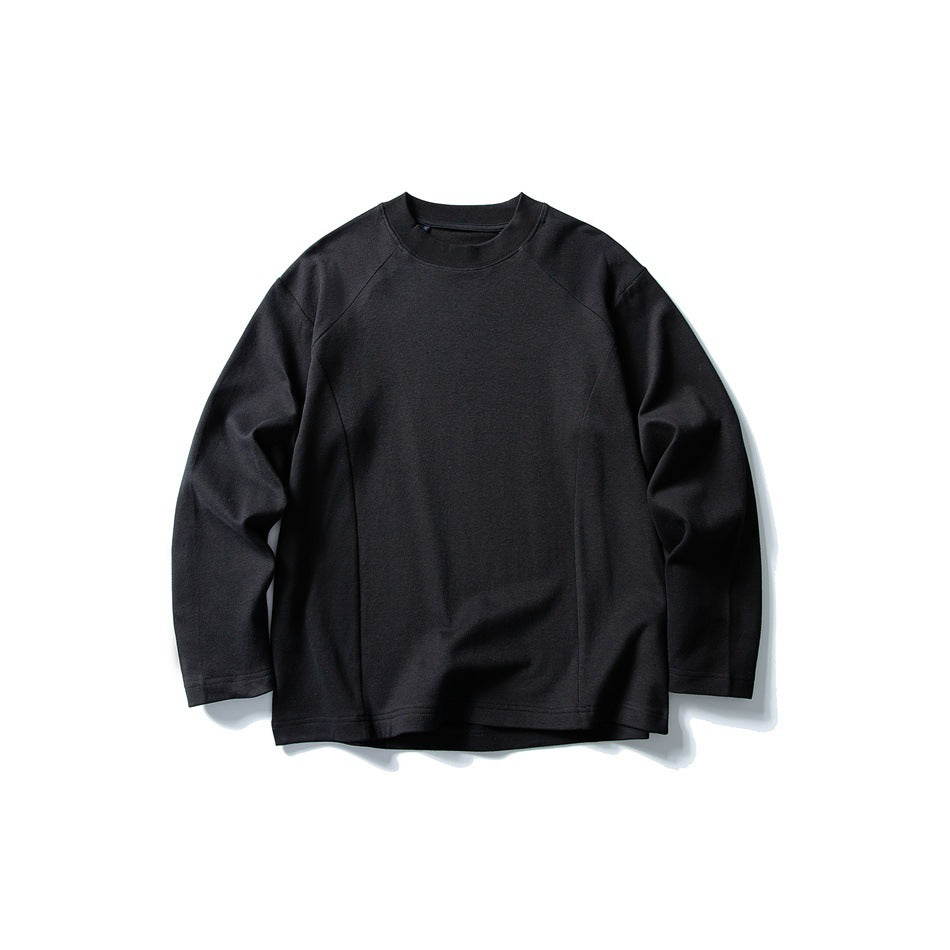 Black long-sleeve crew neck top with raglan sleeves and vertical front seams, flat lay on white background