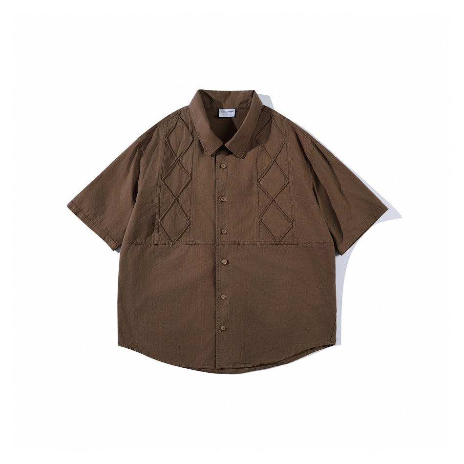 Brown short-sleeve button-up shirt flat lay with diamond-stitched chest panels and a pointed collar