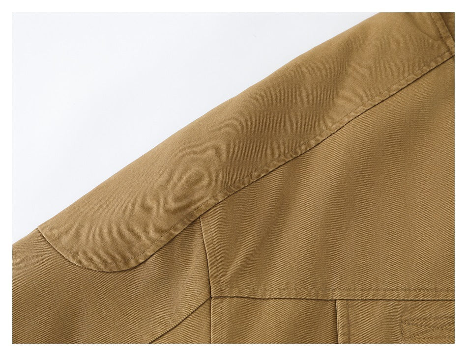 Close-up of the tan jacket's shoulder and back yoke stitching.