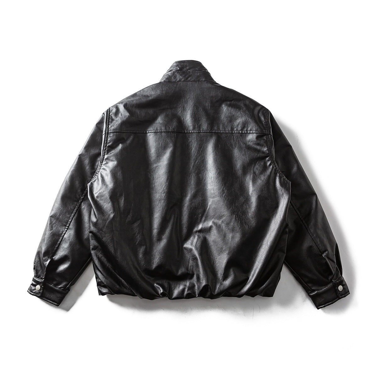 Back view of a black jacket laid flat, with a raised collar, long sleeves, and snap cuffs.