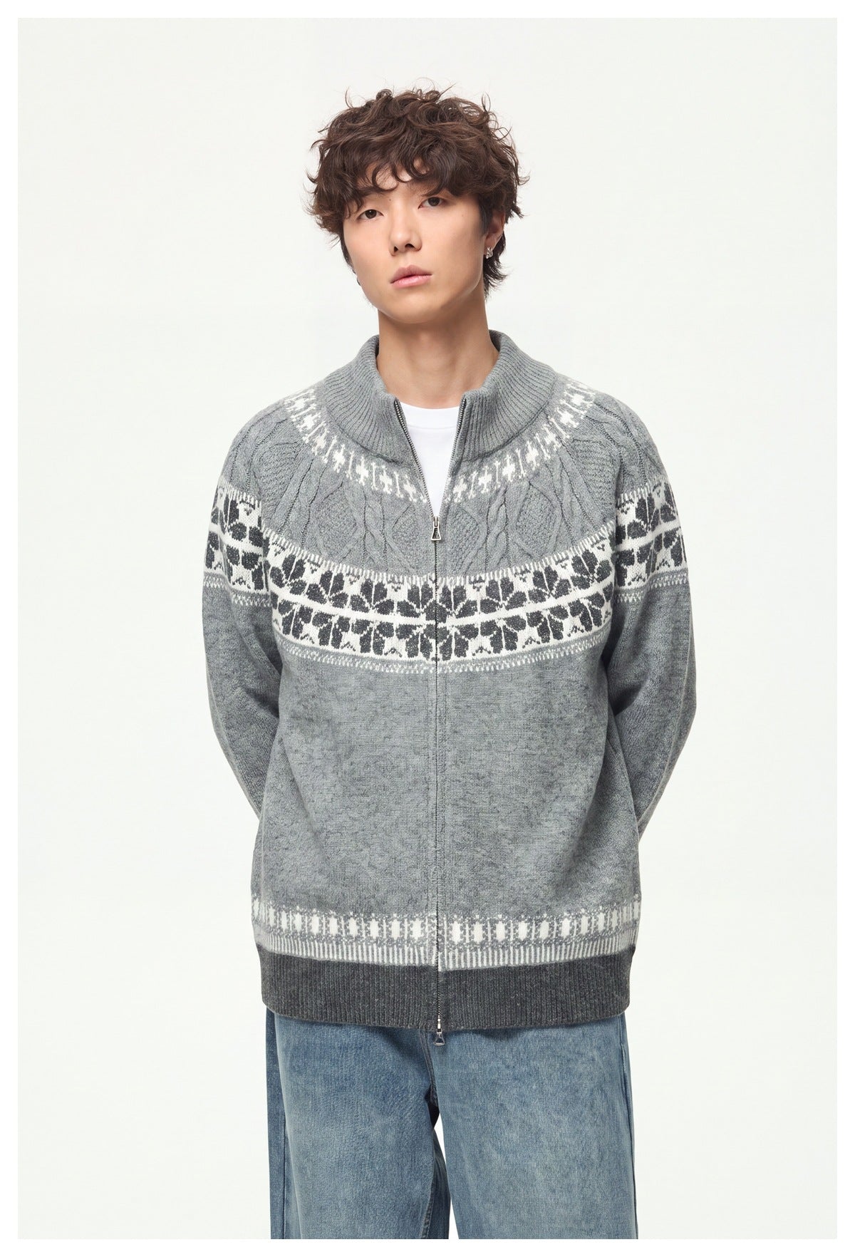 Front view of a model wearing a light gray zip-up knit cardigan with patterned bands and dark ribbed trim.
