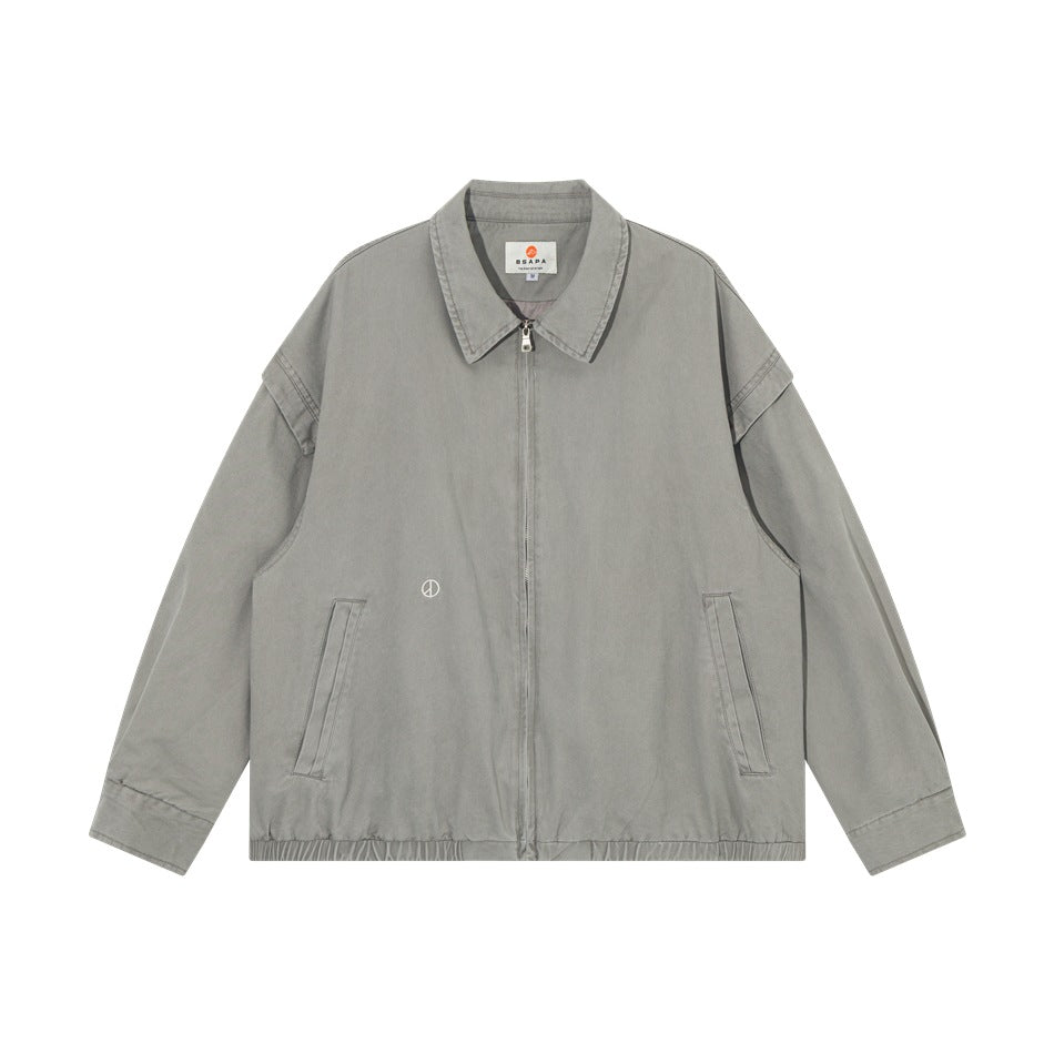 Gray collared zip-front jacket flat lay with angled front pockets, elastic hem and small embroidered peace symbol