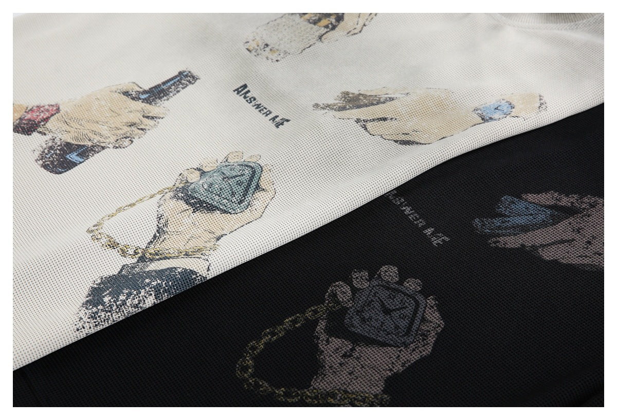 Close-up of cream and black textured knit fabric with printed illustrations of hands and accessories.