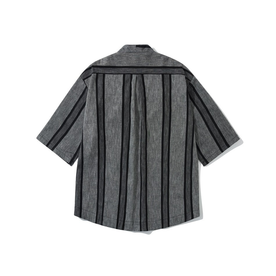 Back view of a charcoal gray short-sleeve shirt with bold black vertical stripes and a center pleat.