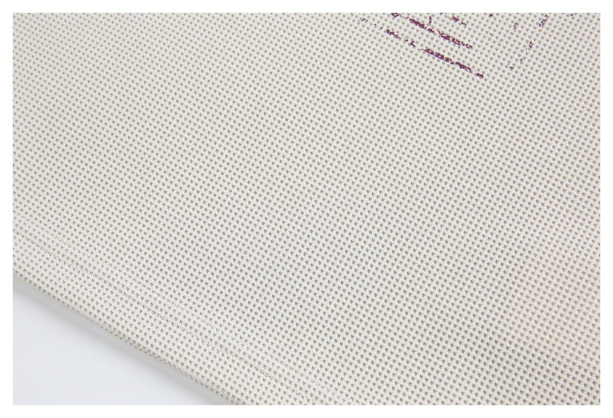 Close-up of the off-white shirt's small-grid textured fabric, with a tiny edge of the printed design visible.
