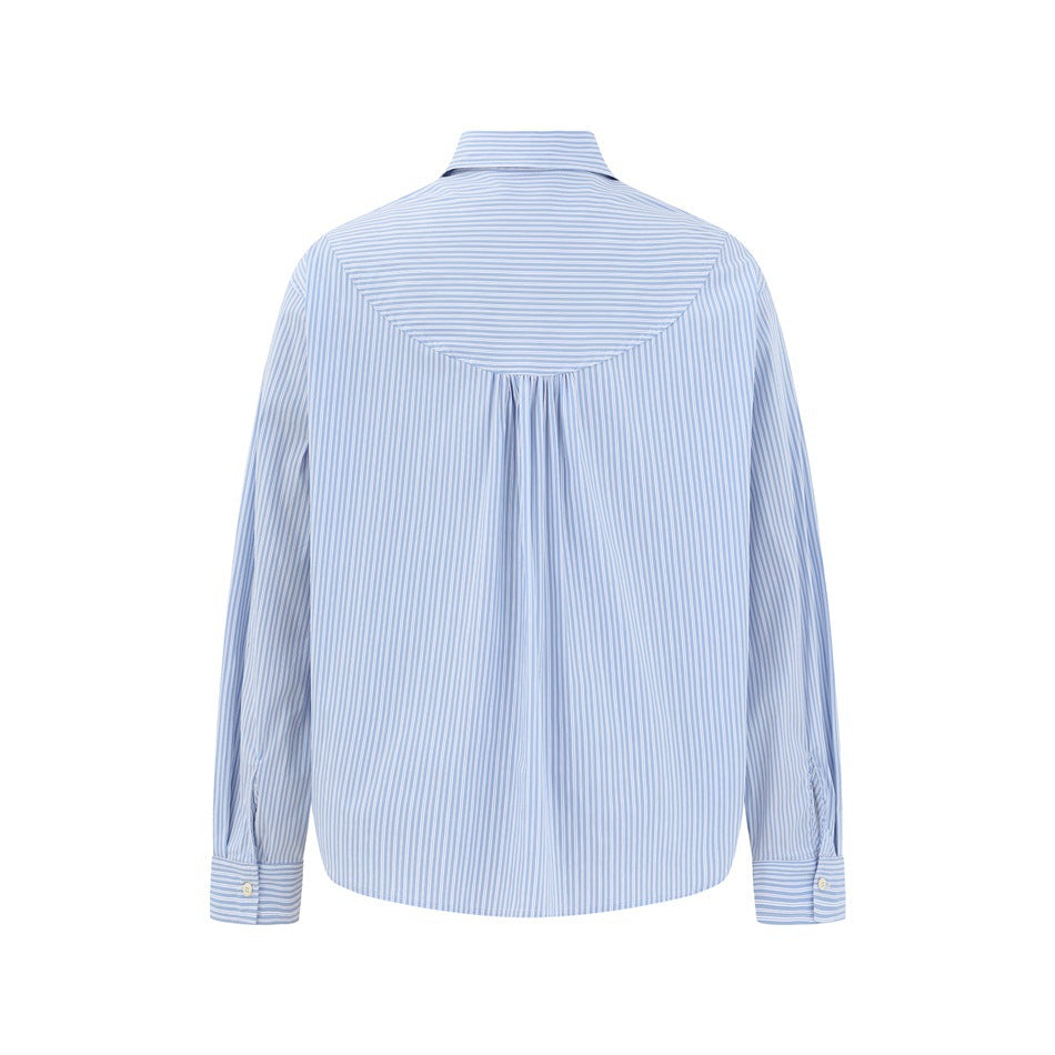 Back view of a light blue and white striped shirt with a horizontal yoke and gathered center pleat.