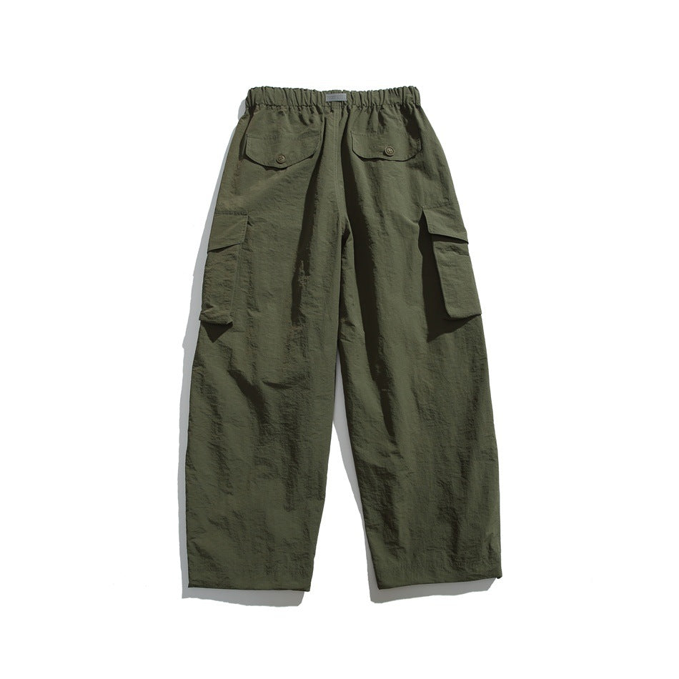 Olive green cargo trousers shown from the back, with an elastic waistband, two buttoned rear pockets, and side cargo pockets.