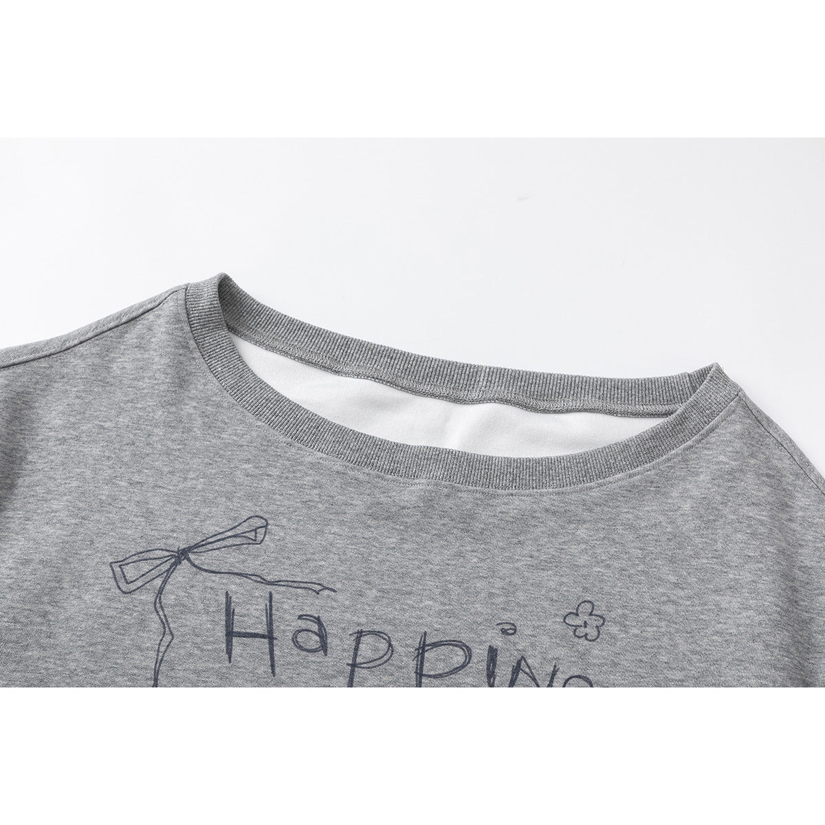 Close-up of a gray sweatshirt's ribbed crew neck and upper chest with a hand-drawn bow and text print.