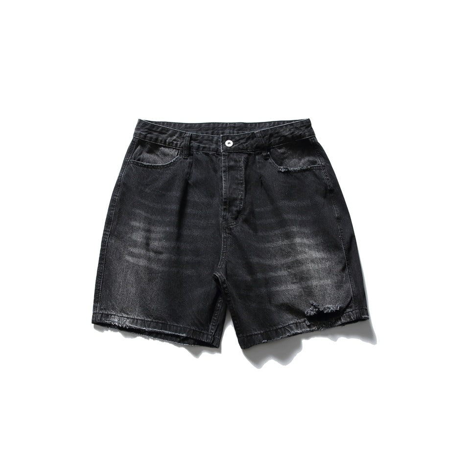 Faded black denim shorts flat lay, front view, with distressed hem hole, frayed hems and button waistband