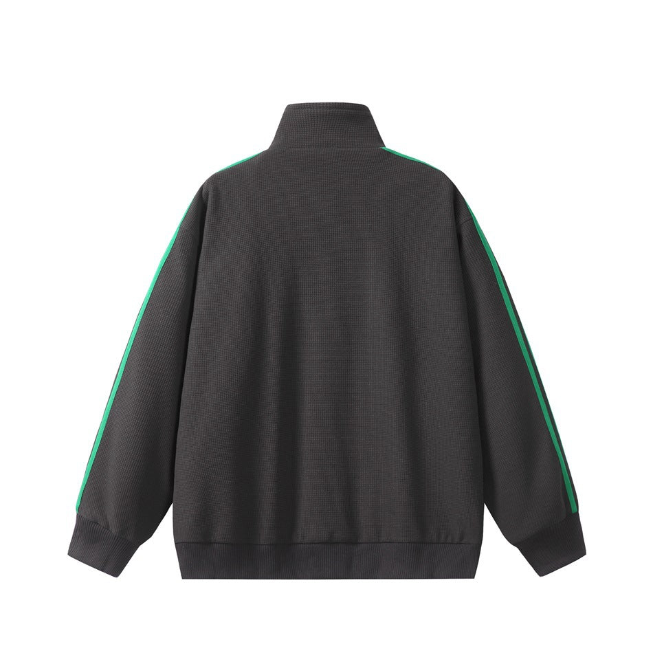 Back view of a charcoal zip-up jacket with green stripes along the shoulders and sleeves.