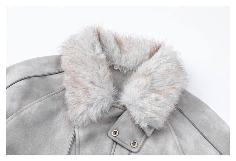 Close-up of a light gray coat's large pale faux-fur collar and double-snap front tab.
