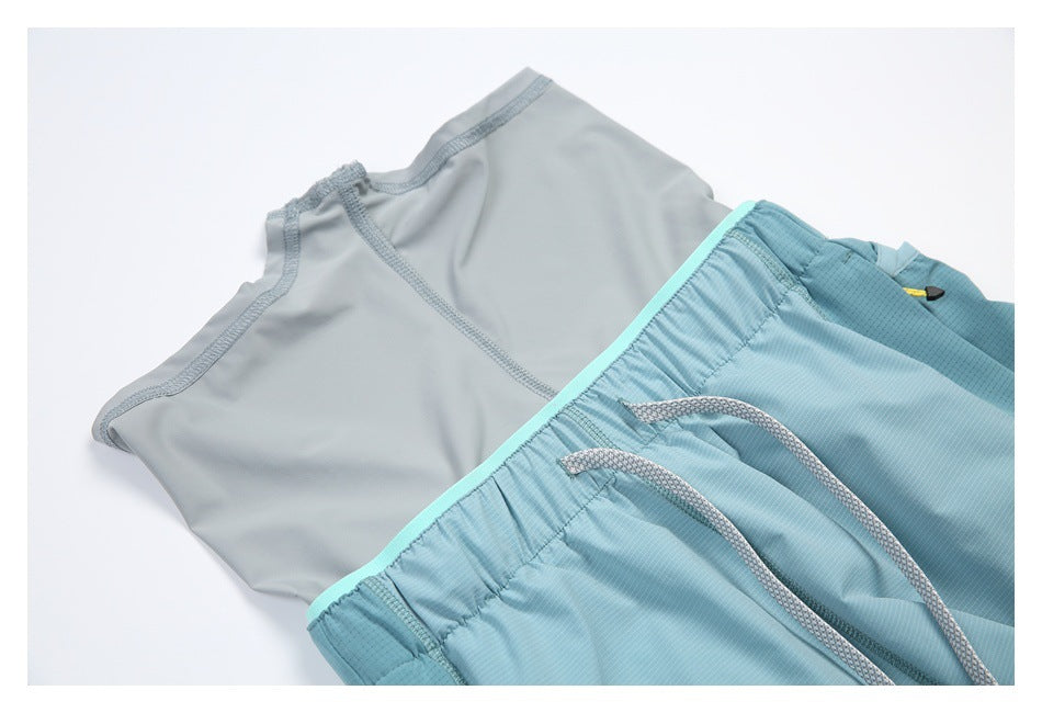 Close-up of blue shorts laid flat, showing the gray inner lining, elastic waist, and drawstring.