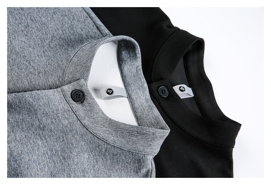 Close-up of gray and black garments showing band collars, buttoned tabs, and small inner labels.