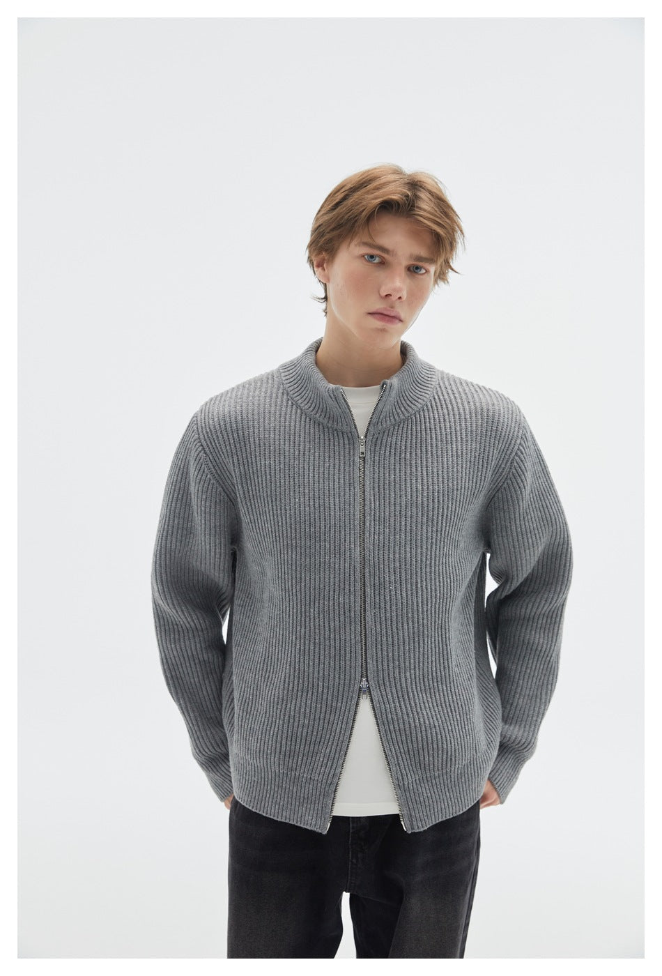 Model wearing a gray rib-knit zip cardigan with a stand collar, layered over a white shirt.