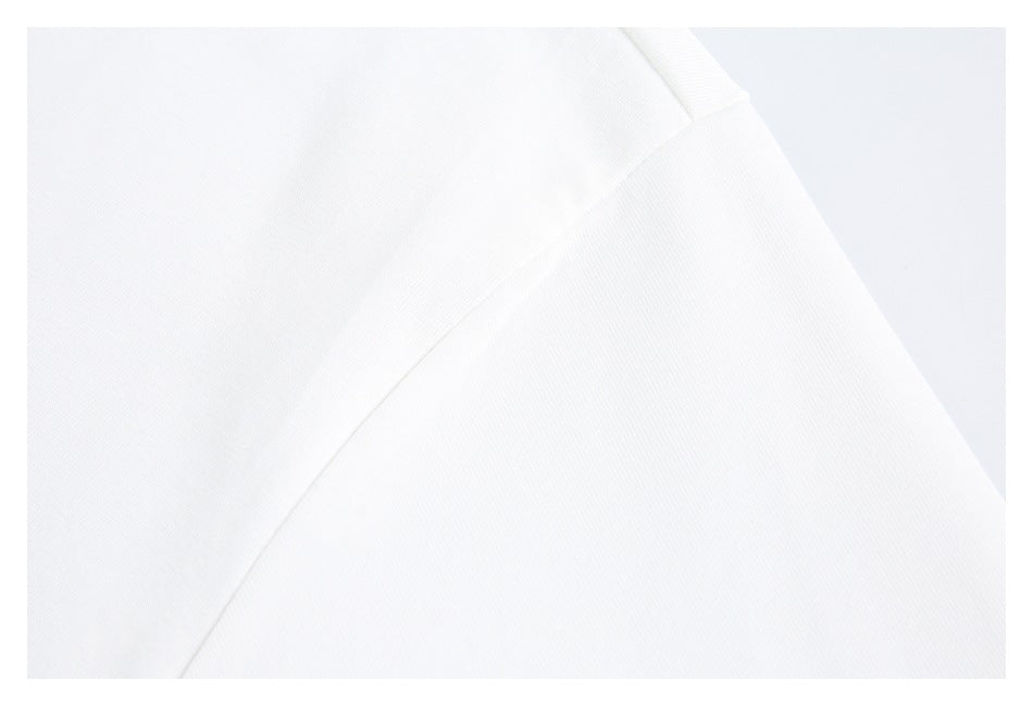 Close-up of a white garment shoulder seam and sleeve area.