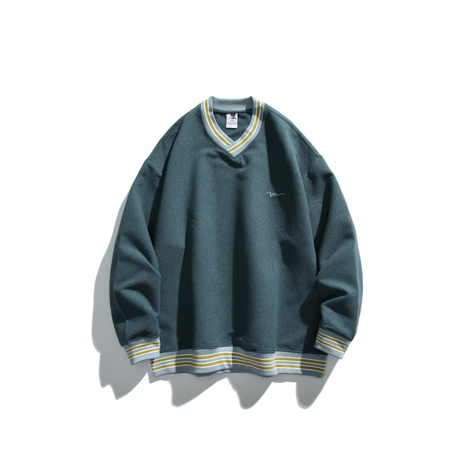 Green V-neck sweatshirt with yellow and light blue striped trim, flat lay with a small chest embroidery