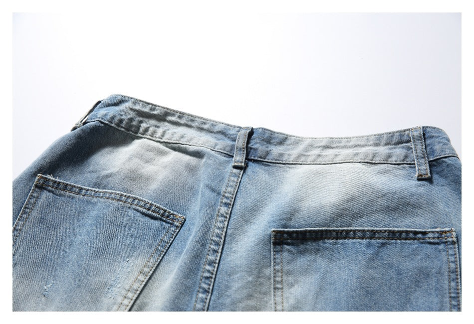 Cropped rear view of light blue washed denim shorts showing the waistband and two back pockets.