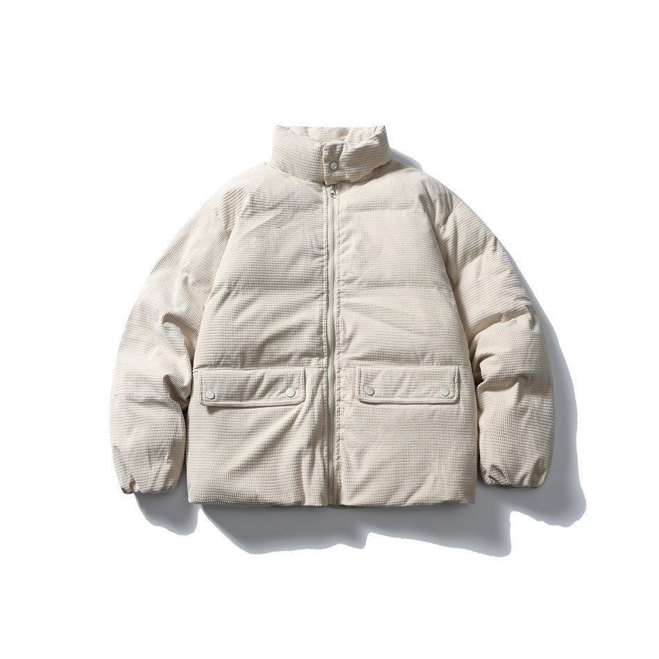 Beige quilted stand-collar jacket with front zip and two snap flap pockets, flat lay