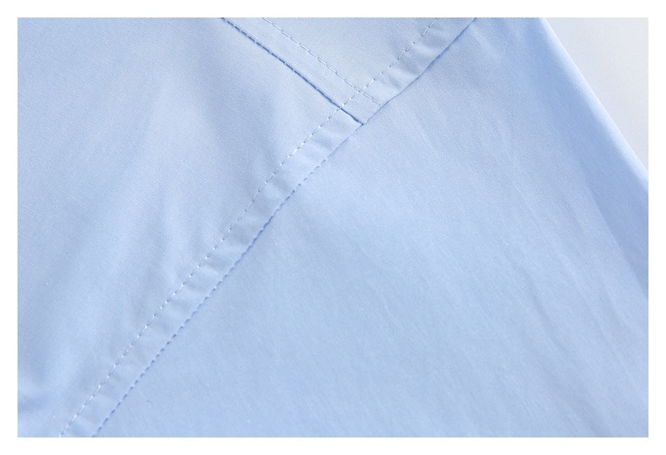 Close-up of pale blue garment panels meeting at a stitched seam.