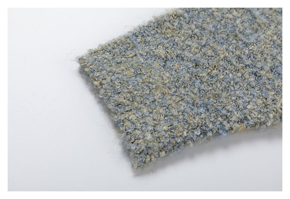 Close-up of the ribbed cuff and fuzzy blue-gray marled knit texture.