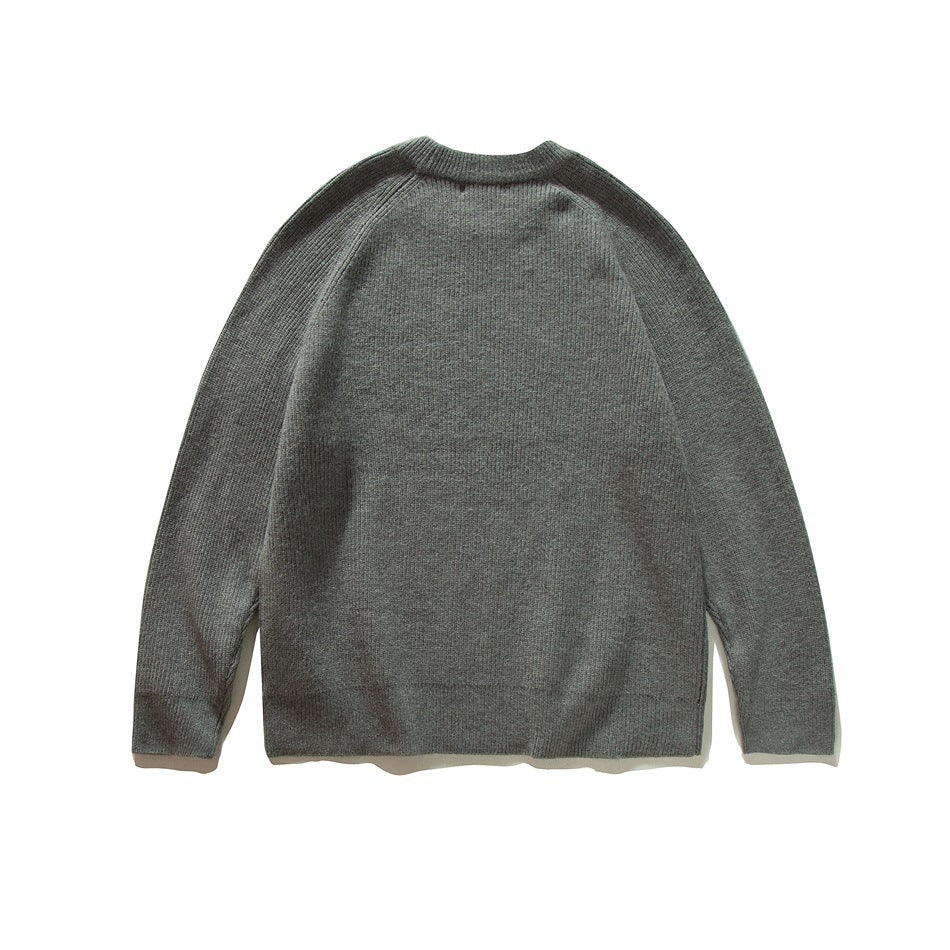 Back view of a charcoal gray crew-neck sweater with raglan sleeves, laid flat.