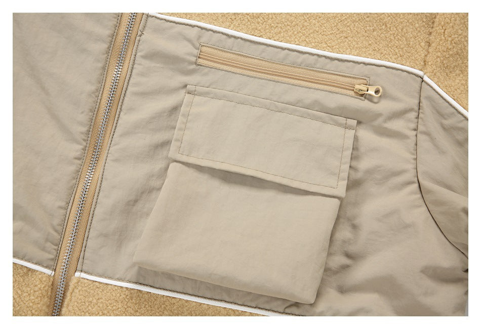Close-up of a tan jacket's chest panel with a zip pocket above a large flap pocket.